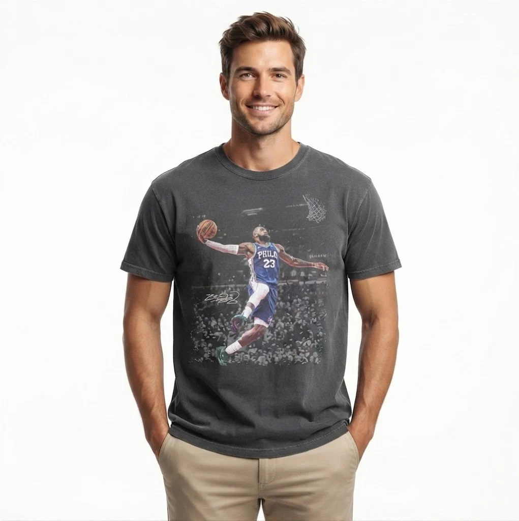Man wearing a charcoal grey t-shirt with a basketball graphic.